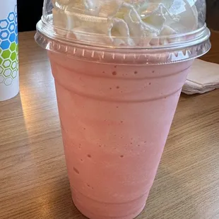 a pink drink with whipped cream