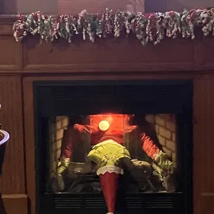 a fire place decorated for christmas