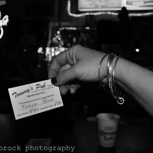 a hand holding a business card