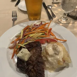 Ribeye steak, grilled veggies and twice baked potato.
