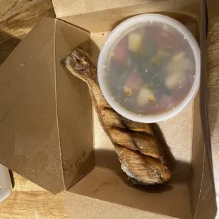 a bowl of soup and a piece of bread