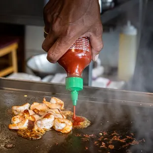 a person cooking food on a grill