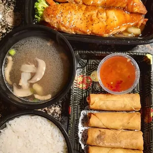 Teriyaki salmon with white rice and soup. Vegetable eggroll appetizer