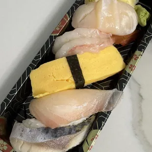 Scallop, sweet shrimp, Egg (tamago), tilapia, and mackerel nigiri Scallop nigiri