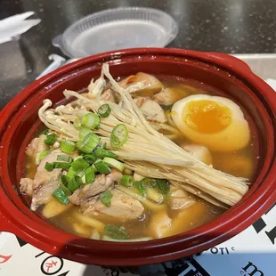 a bowl of soup with an egg