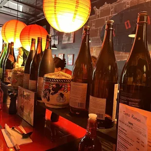 a row of wine bottles on a bar