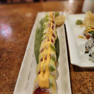 two plates with different types of sushi