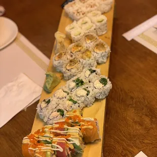 a variety of sushi on a wooden board