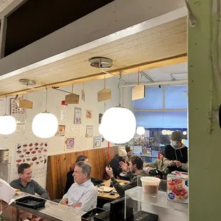 a group of people eating in a restaurant