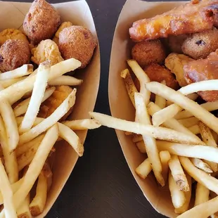 two baskets of fried chicken and french fries