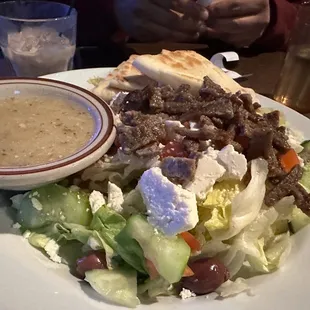 a plate of salad with a side of soup
