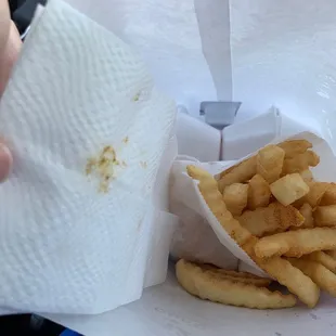 Taco sauce on napkin covering fries