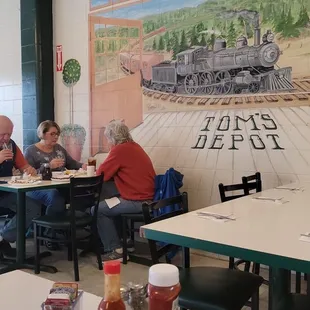 people sitting at tables in a restaurant