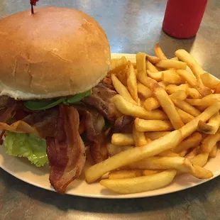 Bacon cheese avocado burger with extra bacon n fries.