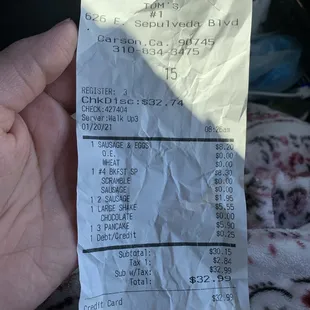 a hand holding a receipt