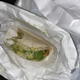 A chicken taco with avocado