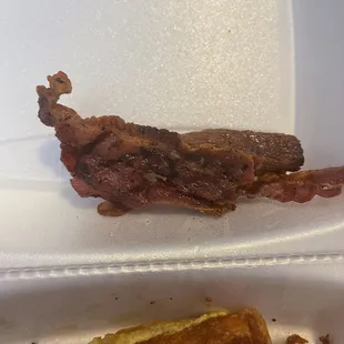 What is this ? Burnt to hell bacon  quality keeps going down here management don't care at all...