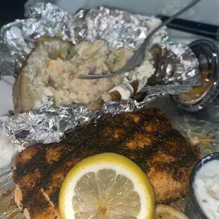 My first time dining here. Grilled Salmon with a loaded baked potato
