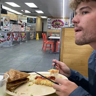 a man eating a slice of pizza