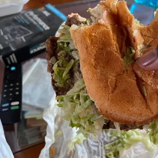 a hand holding a sandwich