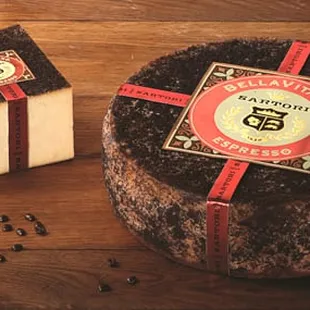 a piece of cheese and a cup of coffee