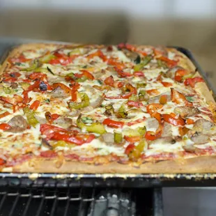 Sicilian Pizza with roasted red and green peppers and sliced Italian sausage.  Simply delicious!!