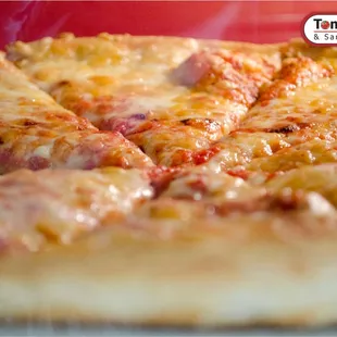 Serving fresh oven hot slices all day long at Tom's since 1964