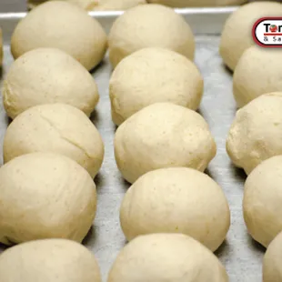 Early morning prep of cutting, weighing and making into balls our fresh dough.