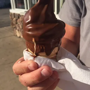 Messily dipped chocolate baby cone- all over the place
