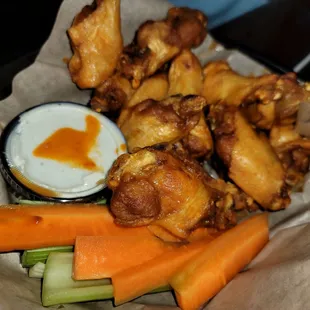 a basket of chicken wings and carrots