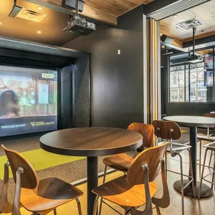 a large screen in the back of the room