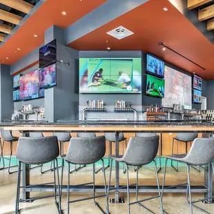 a bar with multiple televisions