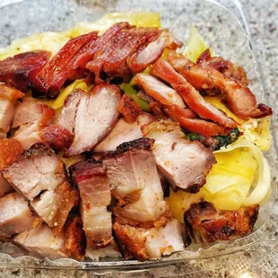 Roasted pork and bbq pork over rice and cabbage