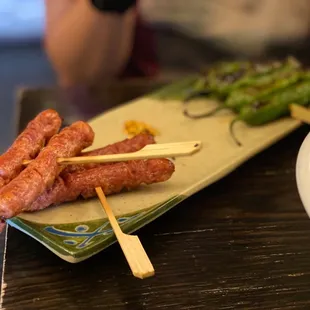 a bowl of soup and a plate of meat skewers