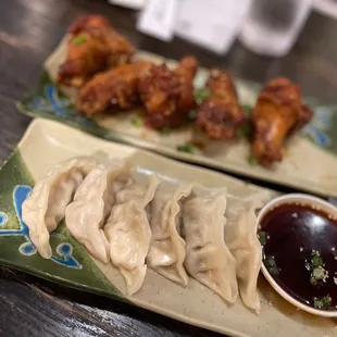 a plate of dumplings and dipping sauce