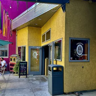 The yellow building is where the coffee shop is located.