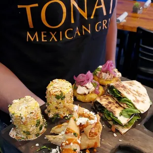 a person holding a tray of food