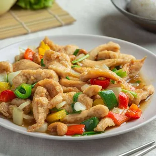 a plate of stir fried chicken and vegetables