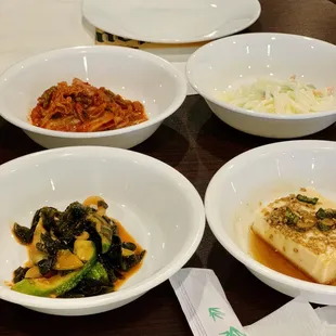 four bowls of food on a table