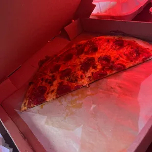 a slice of pizza in a box