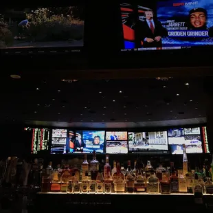 a bar with several televisions on the wall
