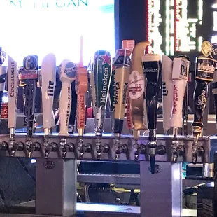 a row of beer taps at a bar