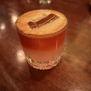 a shot of a drink on a wooden table