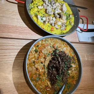 two bowls of food on a wooden table