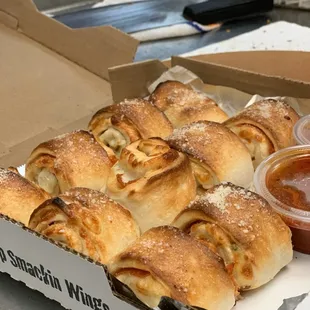 a box of pizza wrapped in doughnuts