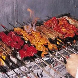 a person cooking food on a grill
