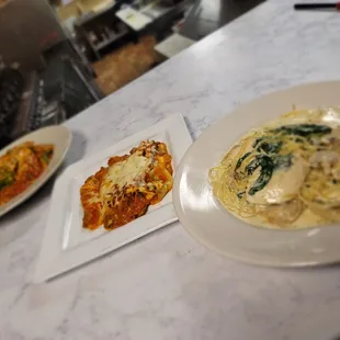 three plates of food on a counter
