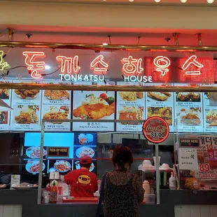 two people standing in front of a restaurant