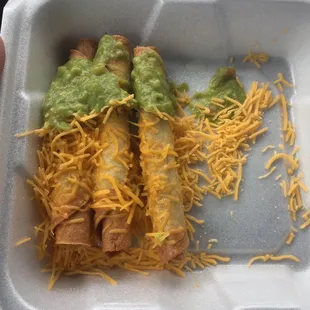 Three rolled tacos with guac and cheese, to go.