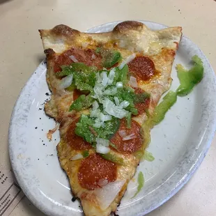 a slice of pizza on a plate
